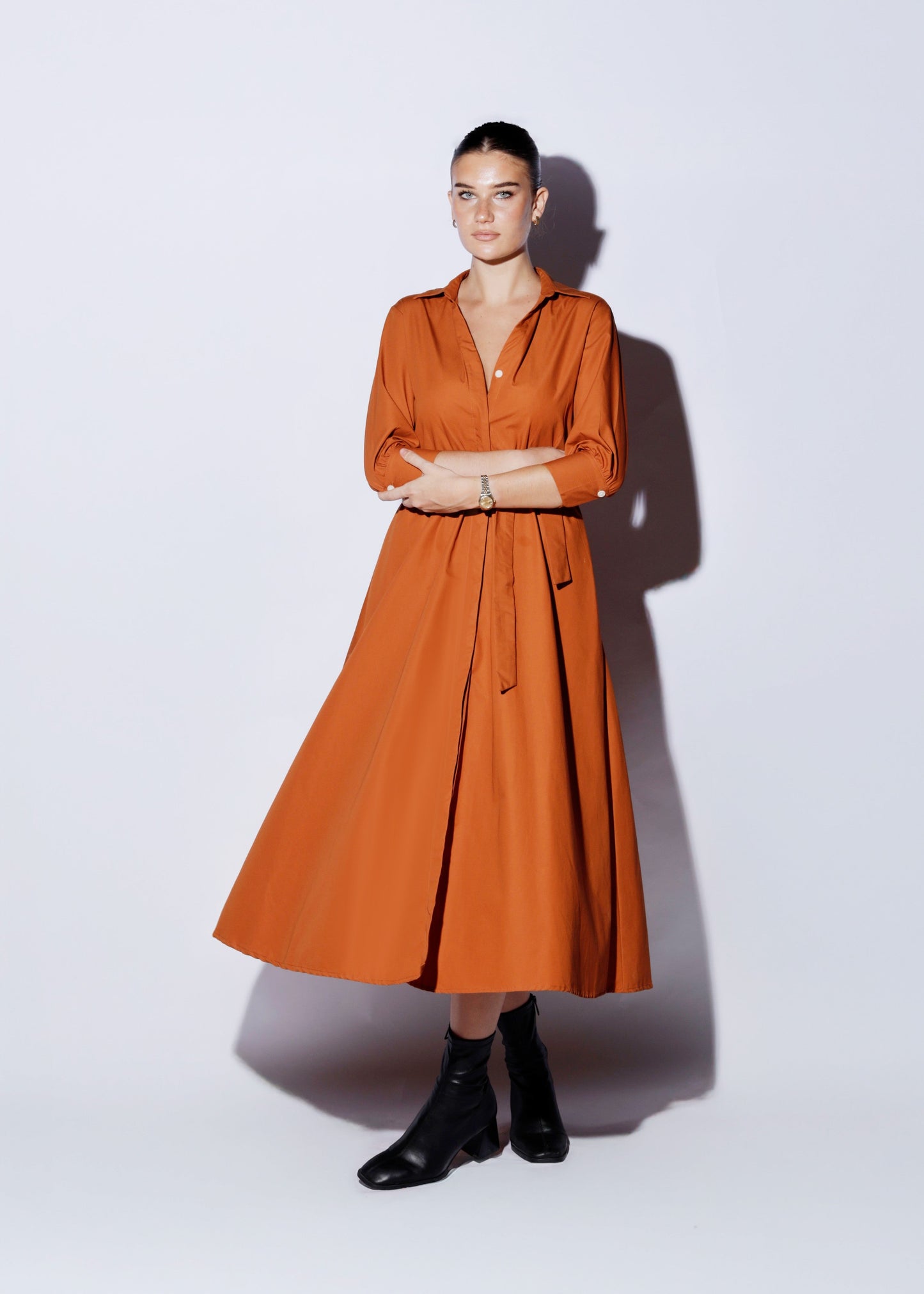 Understated modern event dress with V-front and concealed buttons