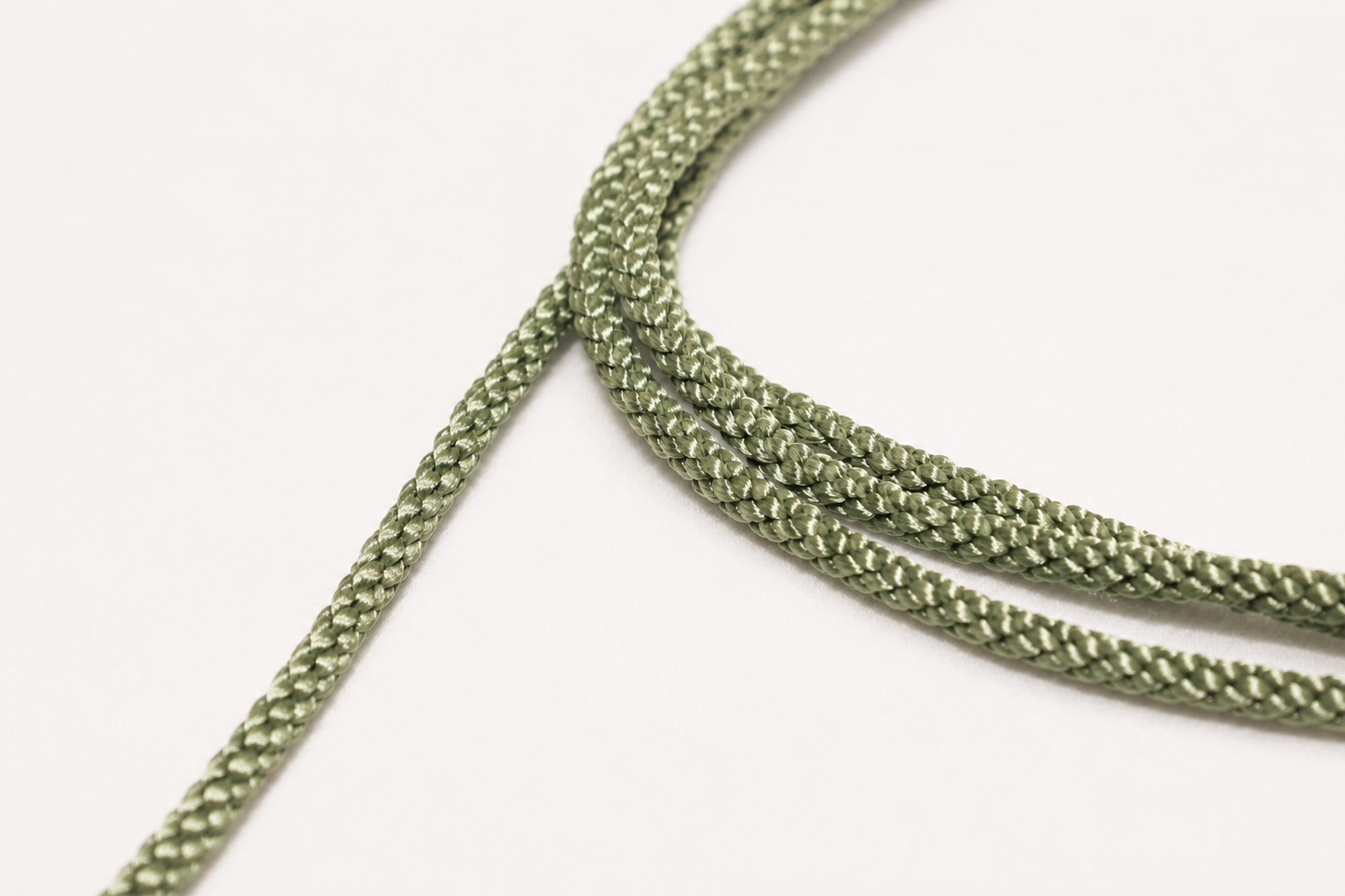 Close-up of green braided cord on a white background