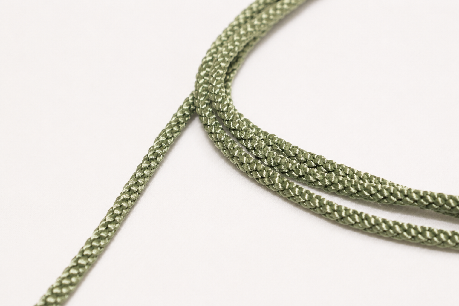 Close-up of green braided cord on a white background