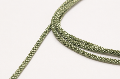 Close-up of green braided cord on a white background