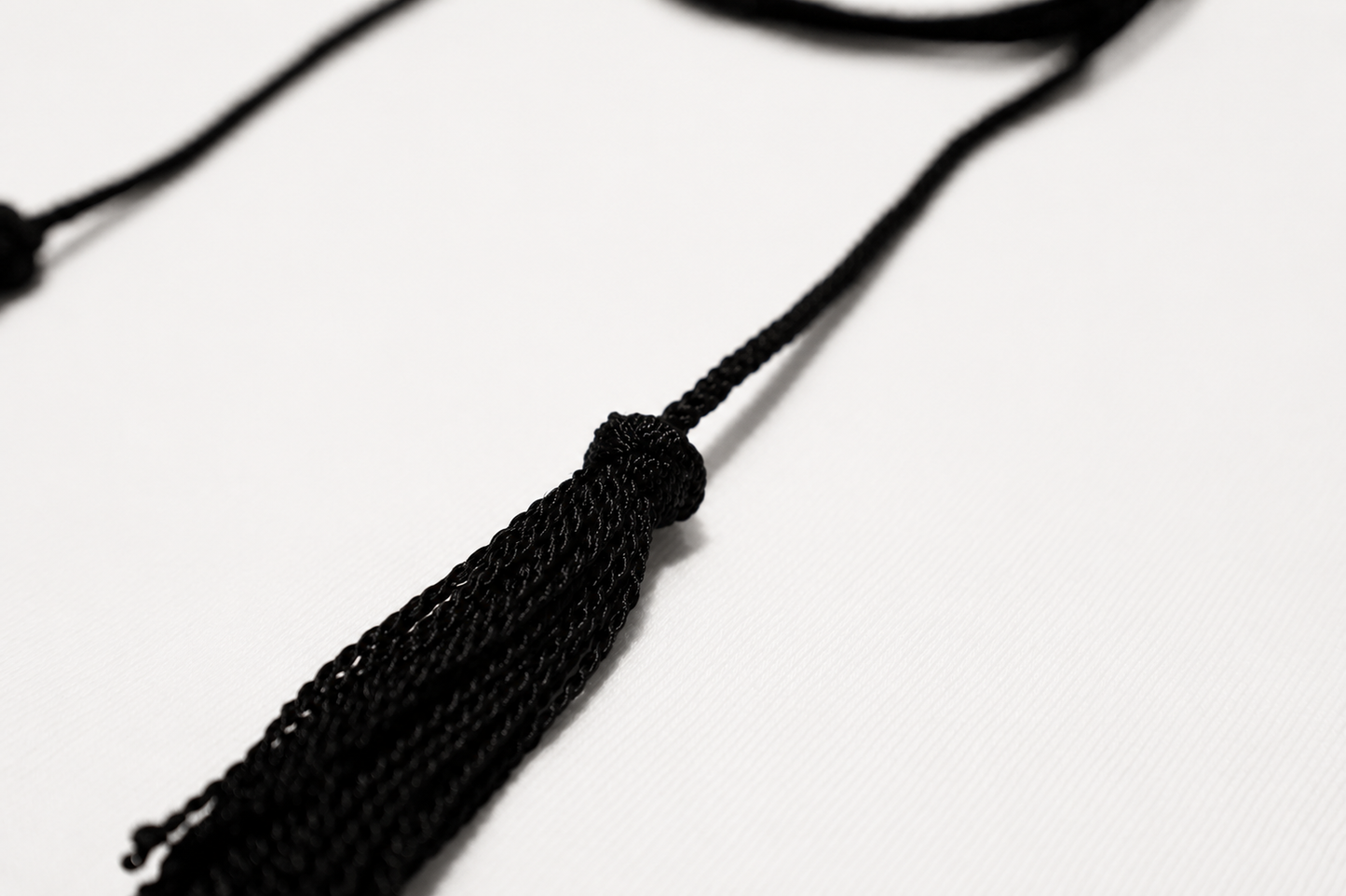 Black tassel on a white background
