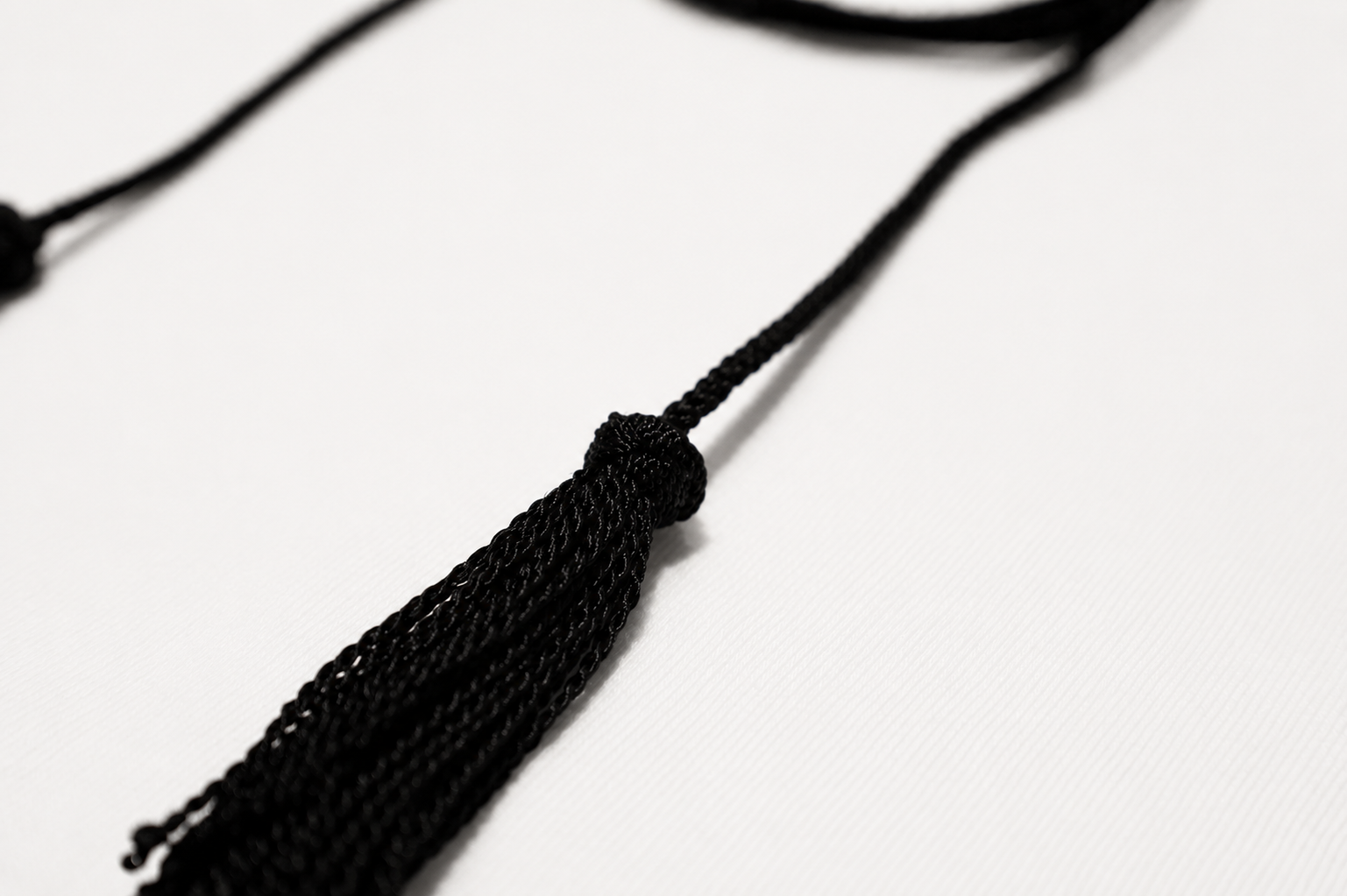 Black tassel on a white background