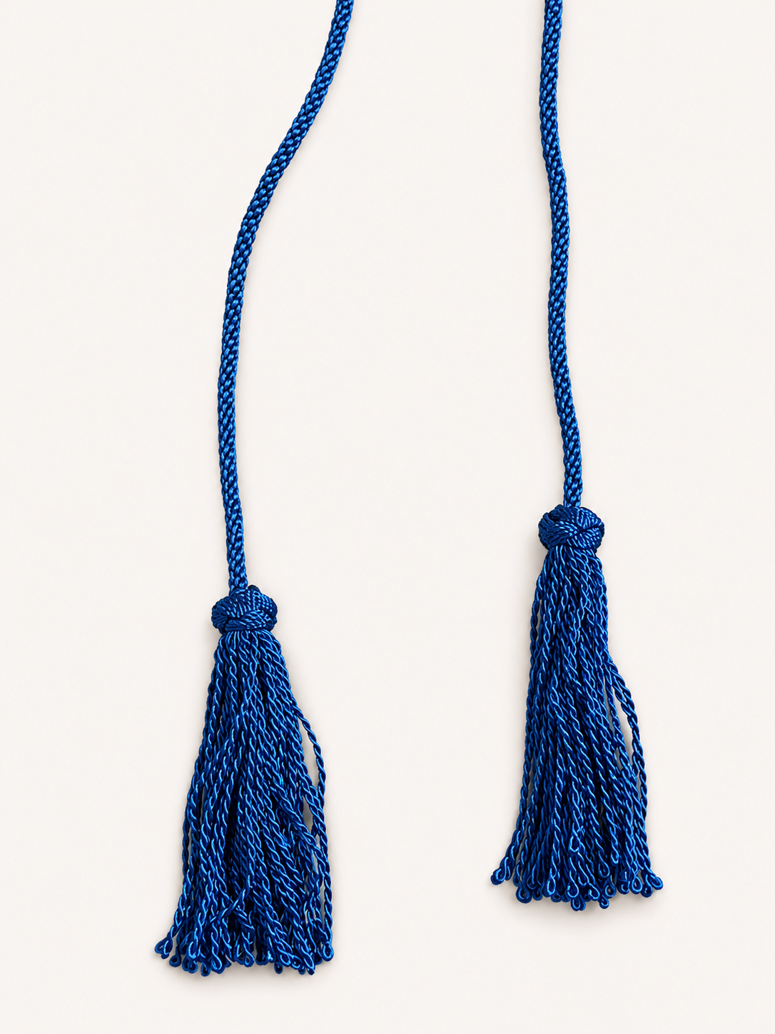 Two blue tassels on a white background