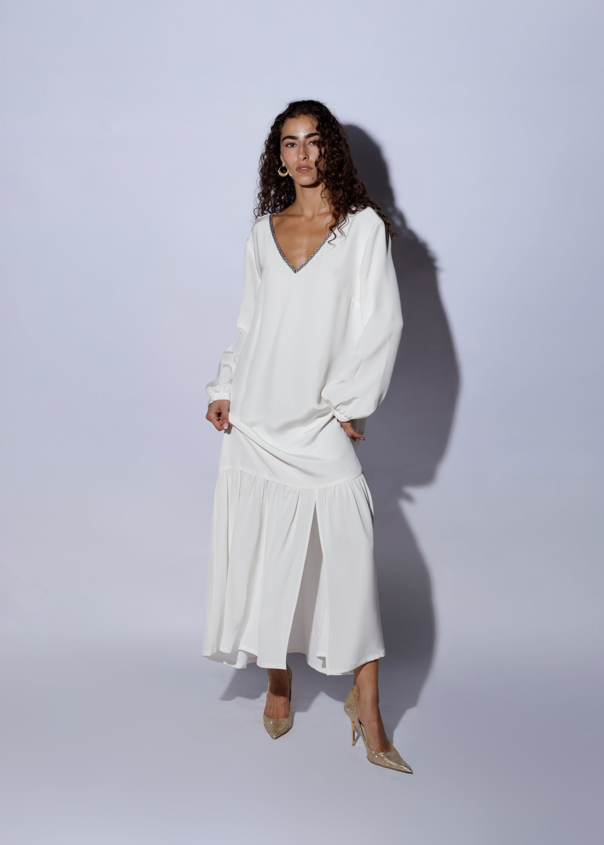 Woman wearing an elegant white silk dress 